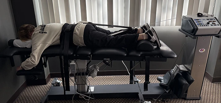 Patient laying on spinal decompression table
