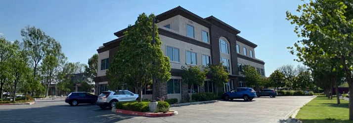 Three‑story commercial office building with large windows