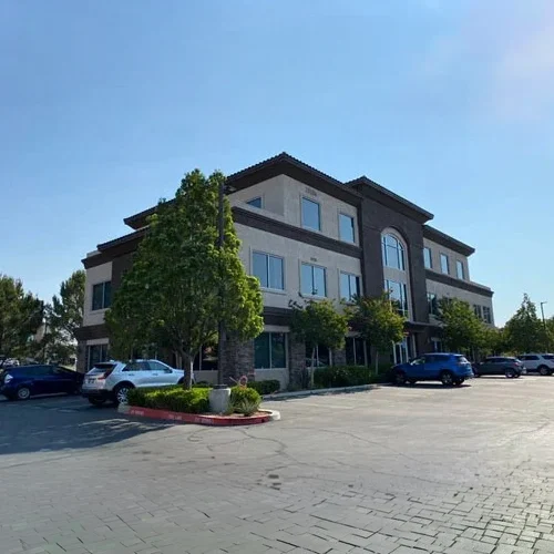 Exterior of a modern two‑story office building with large windows